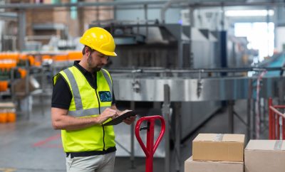 Factory worker using a digital tablet