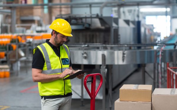 Factory worker using a digital tablet